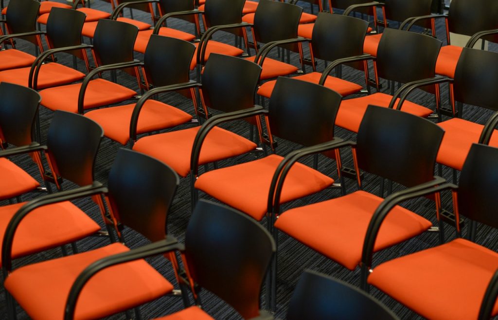 Rows of chairs with red seats