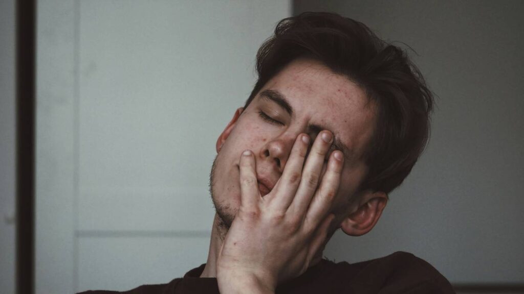 A photo of a young man feeling stressed